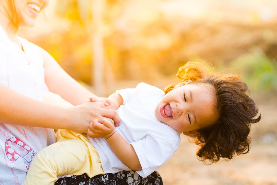 A joyful mother and child laughing together