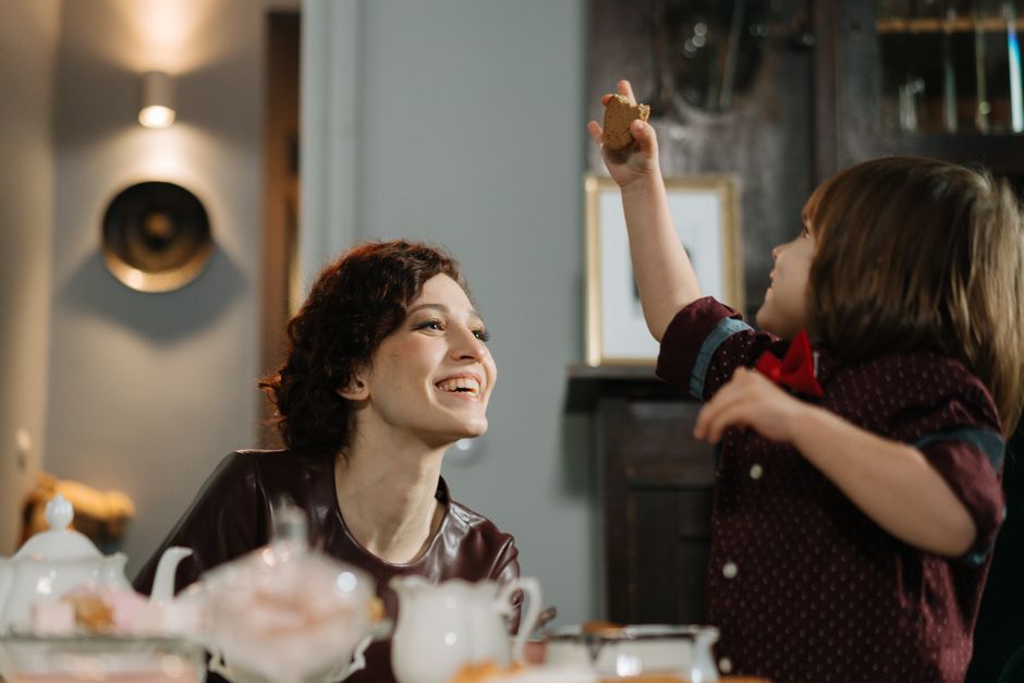 A smiling babysitter and child enjoying time together